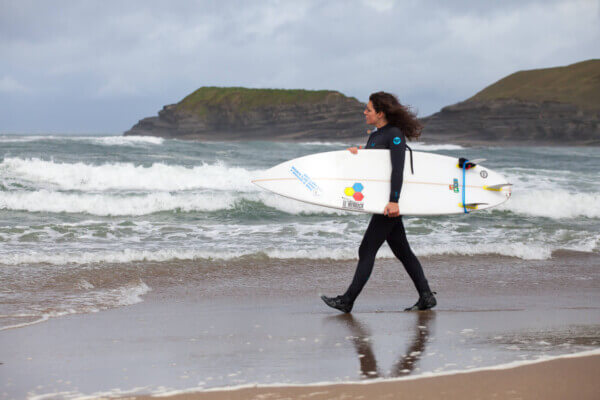 girl with a surfboard activities to enjoy in Ireland