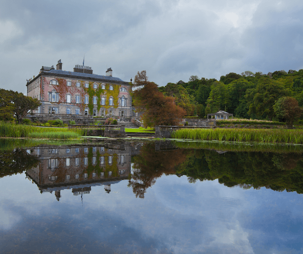 a large house with a lake in front of it Ireland's 5 heritage towns