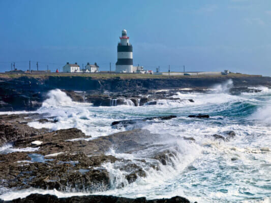 waves crashing against the rocks Ireland's coolest lighthouses