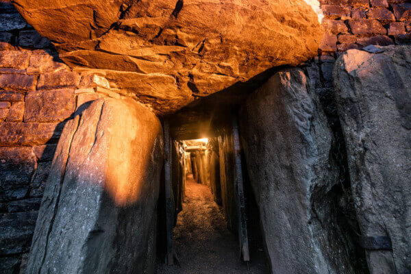 a pasageway surrounded by rocks Newgrange Visitor Center