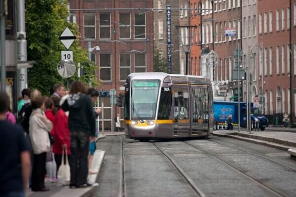 a tram on the street getting around Dublin by bus train and bike