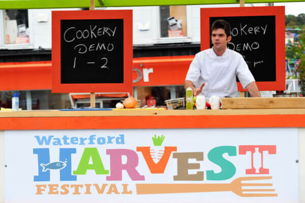 a man behind a counter serving food annual festivals in Ireland