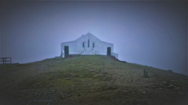 a white building on top of a mountain traveling in County Mayo on a budget