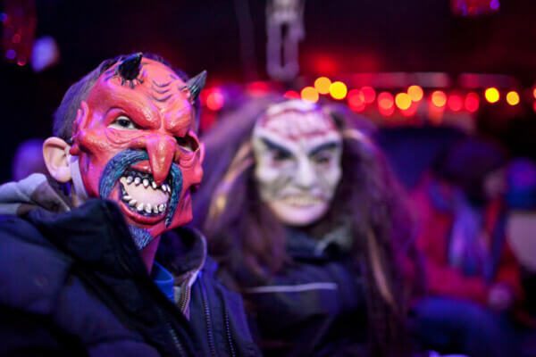two people with masks on their faces Halloween in Ireland