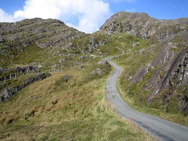 a road in the mountains where to go walking in Ireland