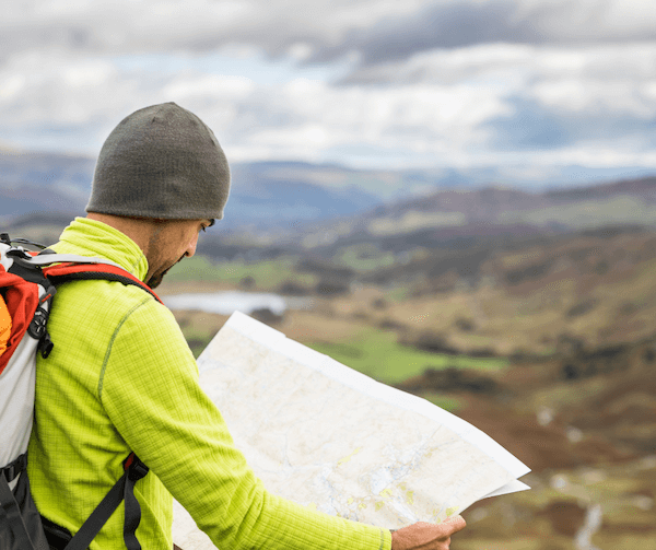 a man holding a map where to go walking in Ireland