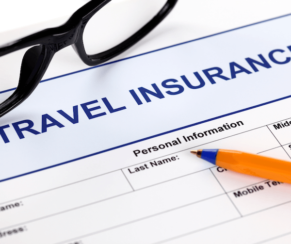 a pen on a piece of paper travel insurance 101