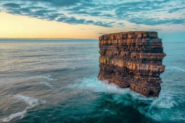 a sea stack in the middle of the ocean plan your Ireland 2023 itinerary