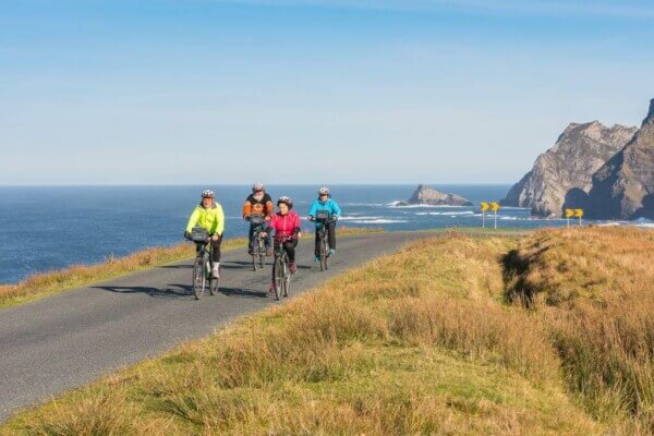 people cycling near the ocean planning a trip to Ireland