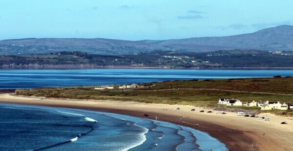 a view of the mountains and a beach Donegal beaches