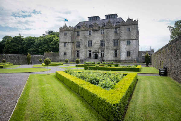 a large building with a garden in front ireland's heritage sites