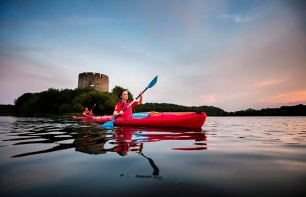 a woman kayaking in a lake Cavan: Ireland's Lake County