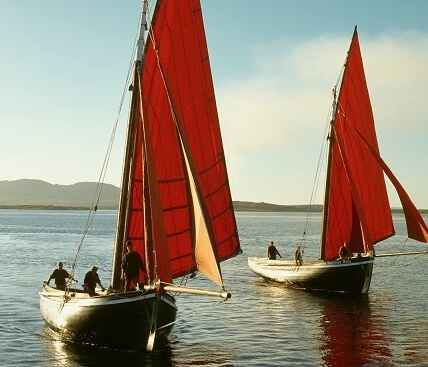 two boats with red sails Galway is the friendliest city in Europe
