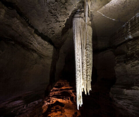 a stalactite in a dark cave Burren Eco Tourism Network