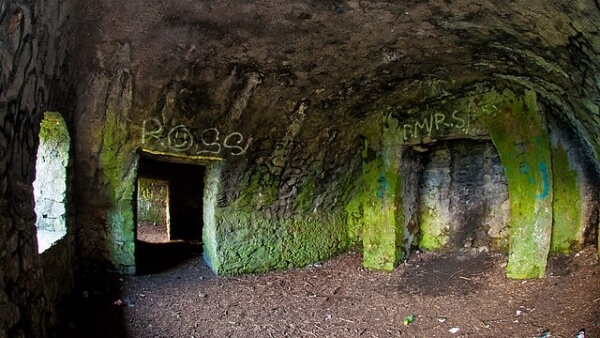 a deserted room in a building with green on the walls 9 of the most haunted places in Ireland
