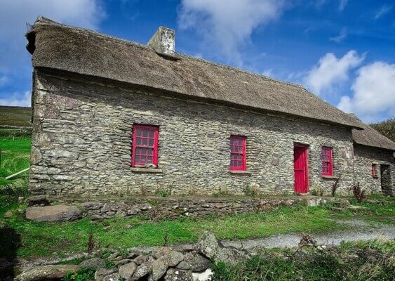 a stone house with red window frames exploring the Dingle Peninsula