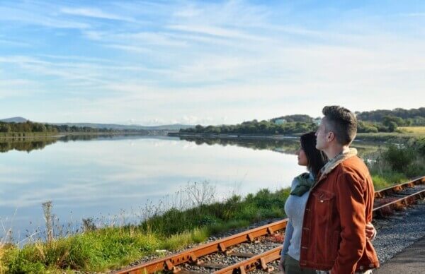 a couple looking at a waterway 5 scenic train rides
