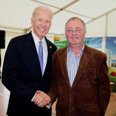 two men smiling and shaking hands County Mayo author