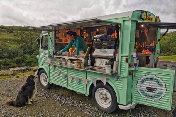 a dog sitting outside a food truck the top 20 irish food trucks