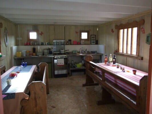 a kitchen with two long tables glamping in Ireland