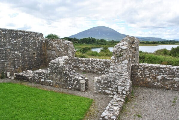 old walls with a mountain and lake in background North Mayo