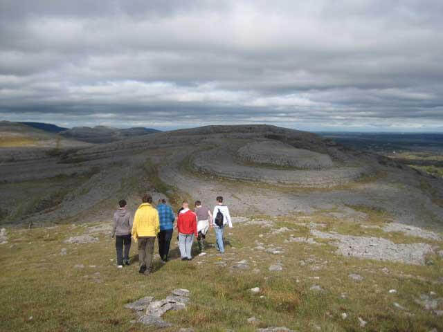 a group of people standing on a hill People of the Burren