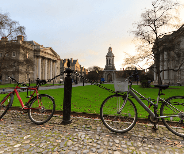 bicycles in front of a green explore Trinity College
