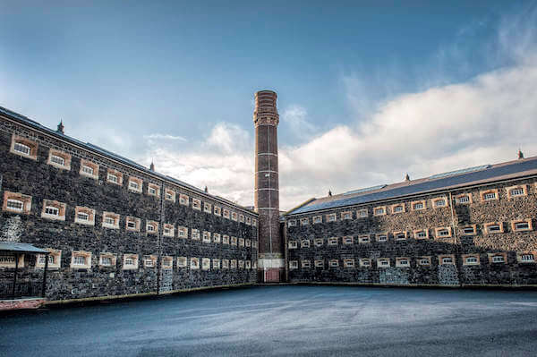 a large building with a tower in the center Belfast's Crumlin Road Gaol