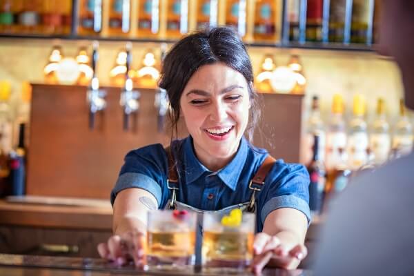 a women serving alcohol best time to visit Ireland