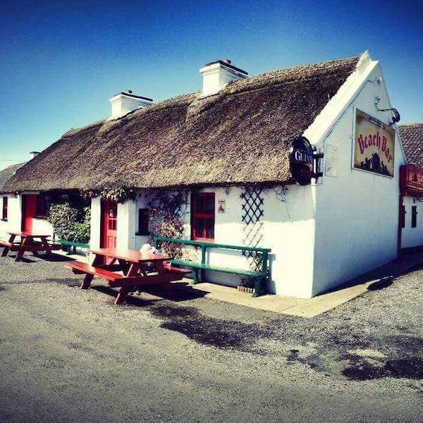 a white thatched cottage 14 of Ireland's oldest pubs