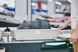 a piece of luggage in a container how to get through airport security