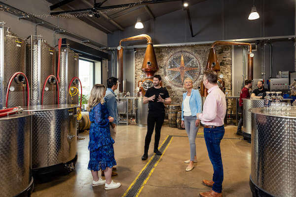 people standing in a whiskey distillery Northern Ireland spirits trail