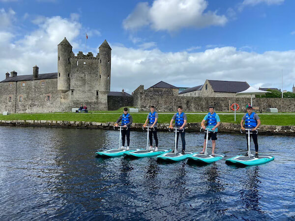boys on stand-up paddles 5 sustainable experiences in Ireland