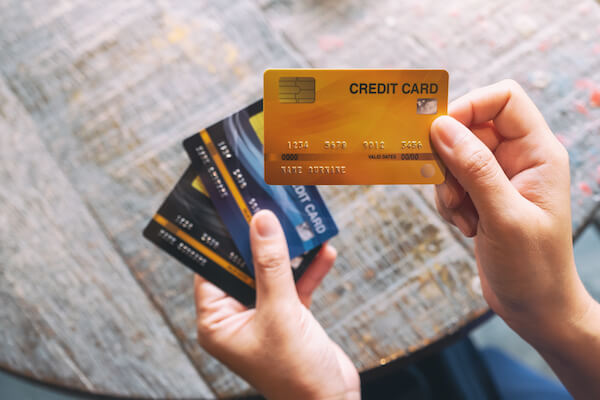 credit cards in a woman's hands car rental in Ireland