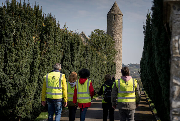 people walking on a path near a round tower Saint Patrick Centre