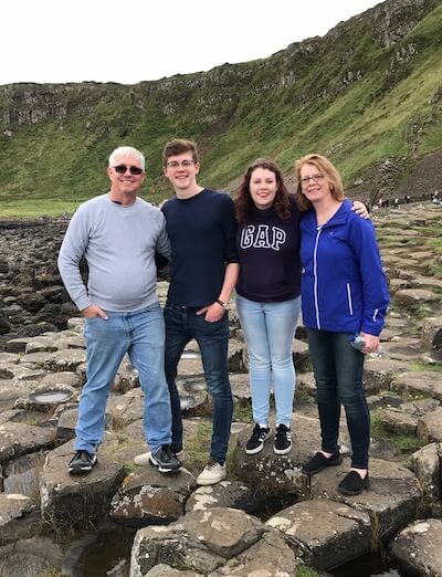 four people standing on rocks About Me and Ireland on a Budget